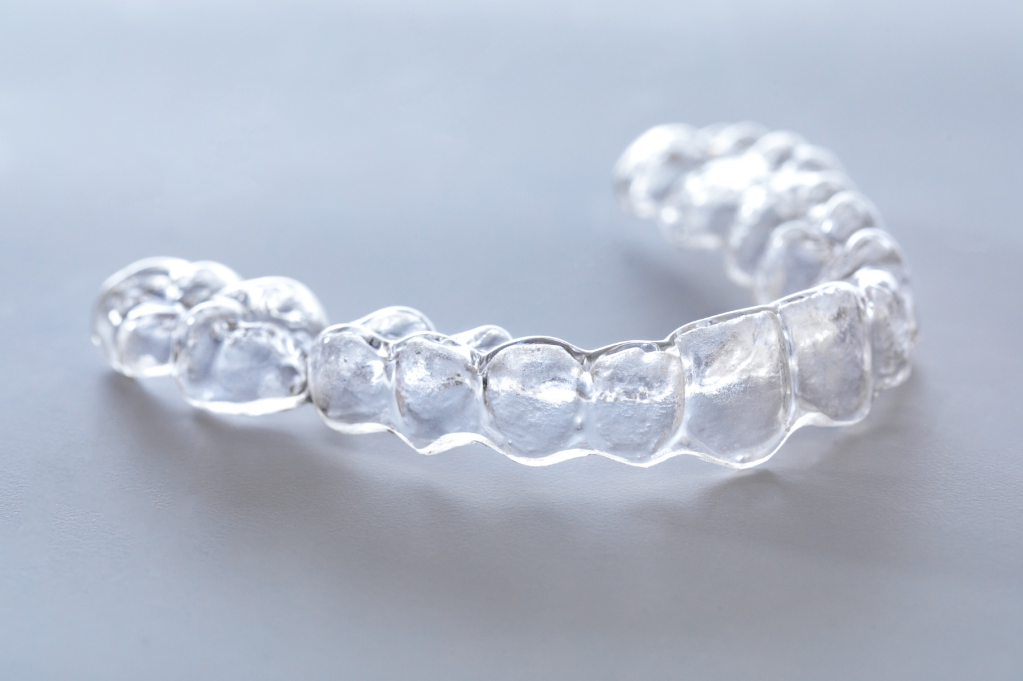 Photograph of a clear retainer showing tooth impressions and edges